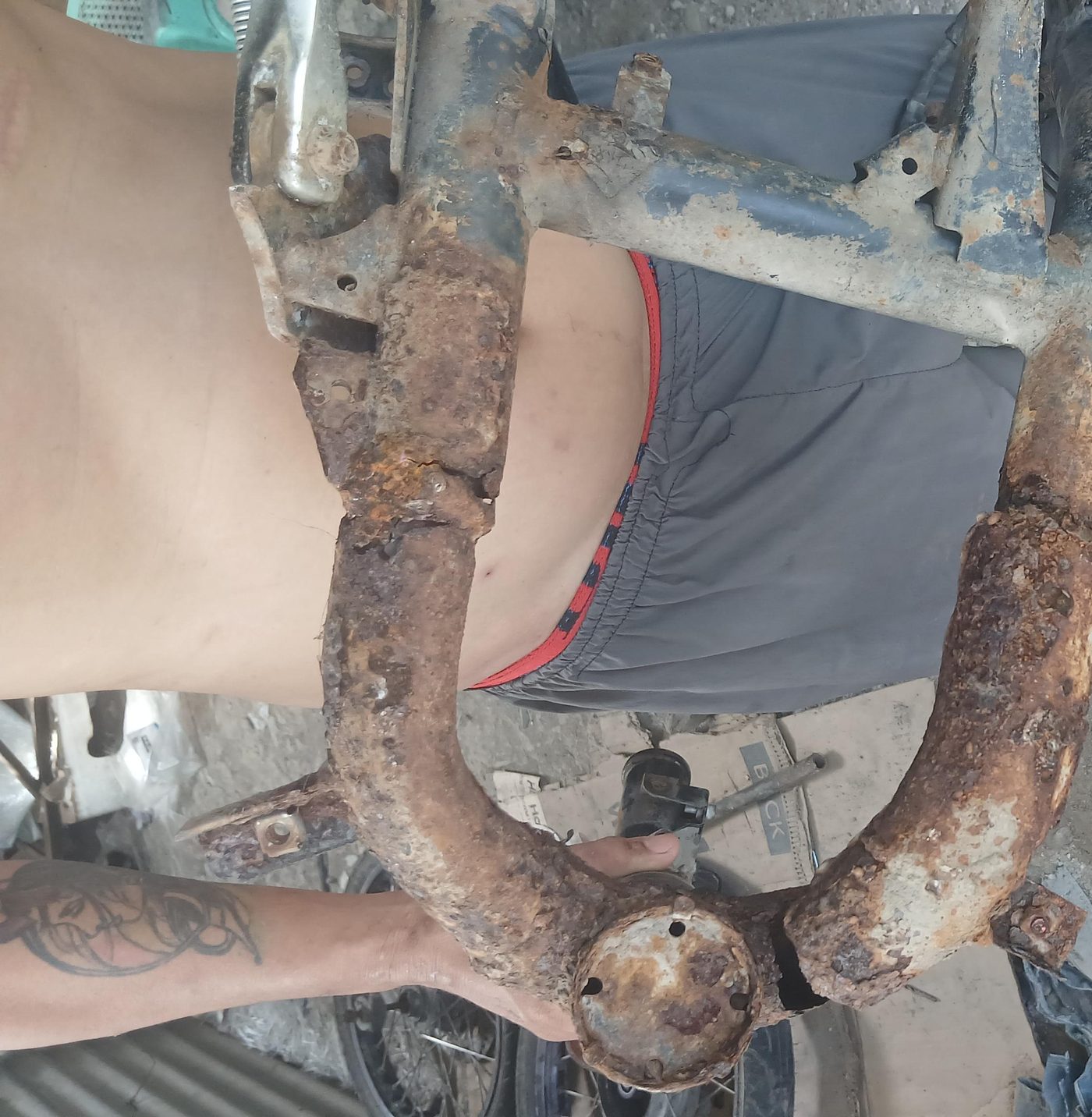 Rusted motorcycle chassis before repair